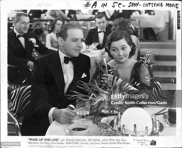 Walter Winchell and Patsy Kelly in a movie still from Wake up and Live, 1939.