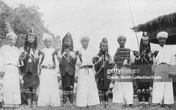 Tribe members in traditional clothing performing a Padaung dance, Myanmar , 1922.