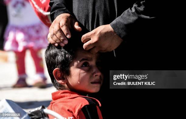 Syrian refugees walk on their way back to the Syrian city of Jarabulus on September 7, 2016 at Karkamis crossing gate, in the southern region of...