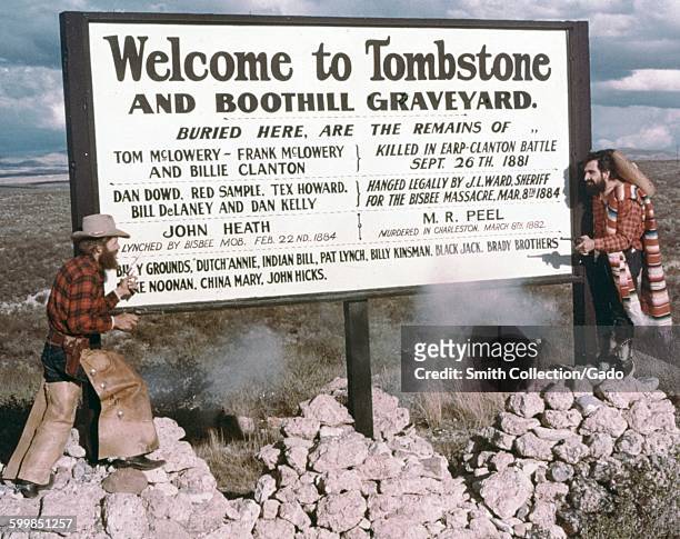 Tourist sign for Tombstone, Arizona and Boothill Graveyard, with list stating that the graveyard is the final resting place of Tom McLowery, Billie...