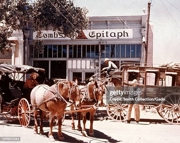 Tombstone Epitaph restaurant, with historical re-enactors driving past in horse drawn stage coaches, Tombstone, Arizona, 1966.