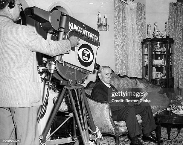 Local politician James Michael Curley shows his biography, "I'd Do It Again," for the camera for Edward R. Murrow's "Person-to-Person" show at his...