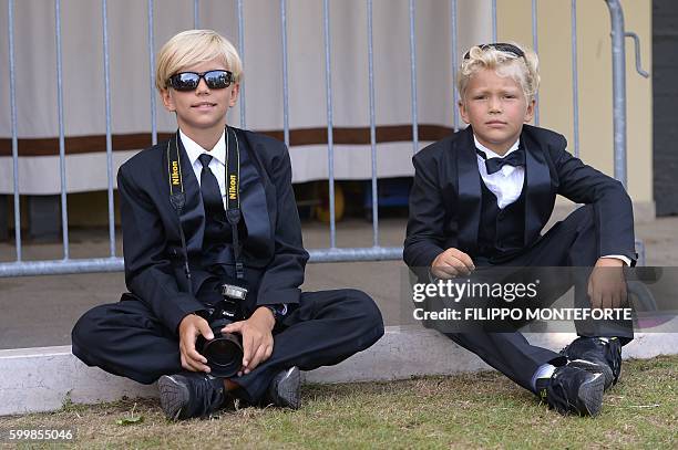 KIds wearing tuxedos wait at the Excelsior Hotel during the 73rd Venice Film Festival on September 7, 2016 at Venice Lido. / AFP / FILIPPO MONTEFORTE