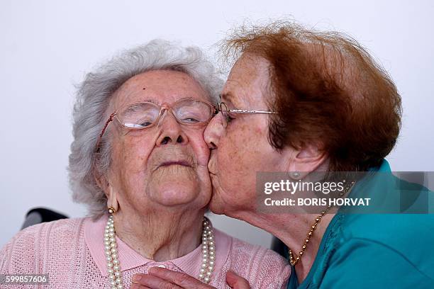 Yvette Florens , 85 years old kisses her mother French eldest person Honorine Rondello , 113 years old, on September 7, 2016 at the retirement home...