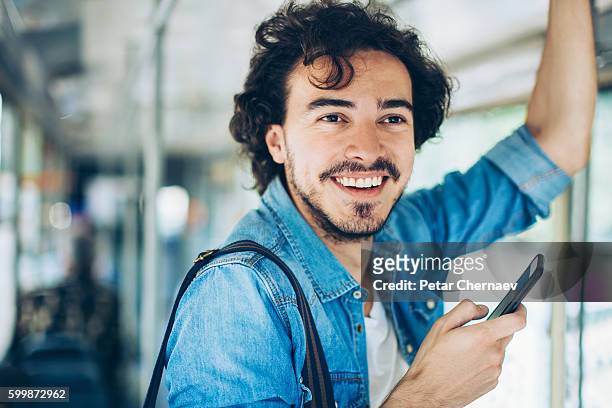 public transport and text messaging - tram stock pictures, royalty-free photos & images