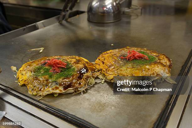 okonomiyaki, japanese savoury pancakes, hiroshima, japan - hiroshima stock pictures, royalty-free photos & images