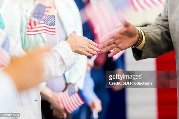 local politician shaking hands with supporters at event - democratic party stockfoto's en -beelden