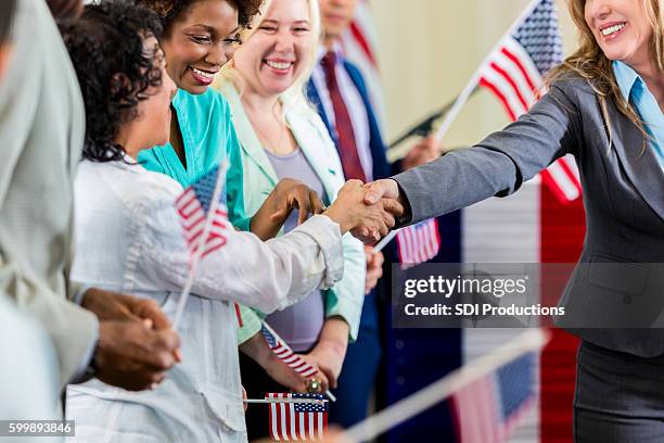 local political candidate shaking hands with supporters at event - political press conference stock pictures, royalty-free photos & images