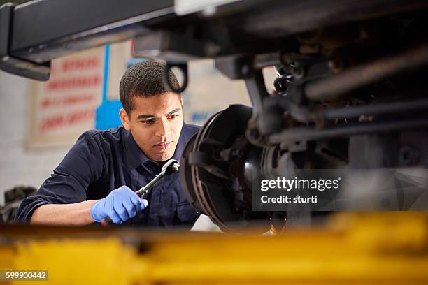 mechanic repairs - putting gloves stock pictures, royalty-free photos & images