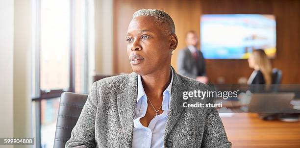 senior businesswoman in boardroom - androgynous professional stock pictures, royalty-free photos & images