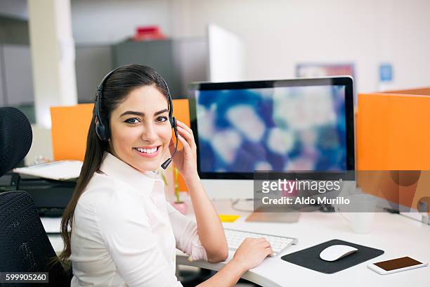 office worker with a telephone headset - administrative professionals stockfoto's en -beelden