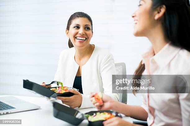 cheerful businesswomen having healthy lunch together in office - smart casual lunch stock pictures, royalty-free photos & images