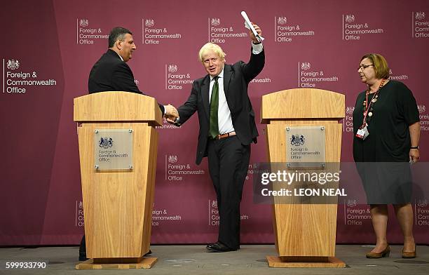 British Foreign Secretary Boris Johnson ), and Chief Negotiator for the Syrian Opposition, Dr Riyad Hijab, host a joint news conference following...