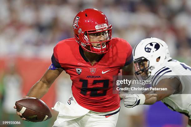 Quarterback Anu Solomon of the Arizona Wildcats scrambles to pass during the college football game against the Brigham Young Cougars at University of...