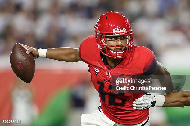 Quarterback Anu Solomon of the Arizona Wildcats scrambles to pass during the college football game against the Brigham Young Cougars at University of...