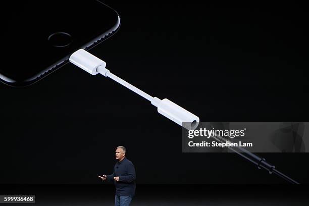 Apple Senior Vice President of Worldwide Marketing Phil Schiller introduces a Lightning to 3.5 mm audio jack adapter during a launch event on...