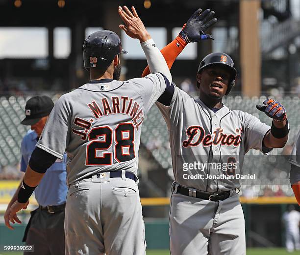 Martinez of the Detroit Tigers congratulates Justin Upton after Upton hit a three run home run in the 2nd inning against the Chicago White Sox at...