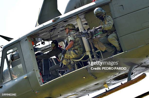 Huey UH-1 Mexican army helicopter overflies the area on September 7, 2016 in El Chauz, Michoacan State, Mexico, near the place where a police...