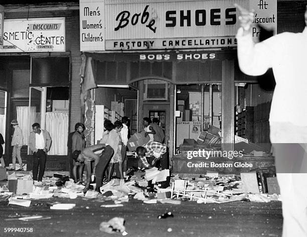 People loot a store on Blue Hill Avenue during riots in the Roxbury neighborhood of Boston on June 3, 1967.