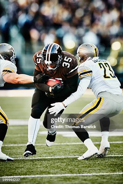 football running back breaking past defenders - american football team stock pictures, royalty-free photos & images