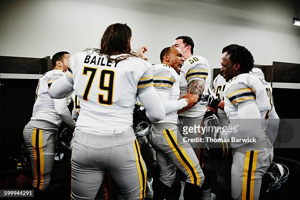 football players getting motivated before game - american football player celebrating stock pictures, royalty-free photos & images