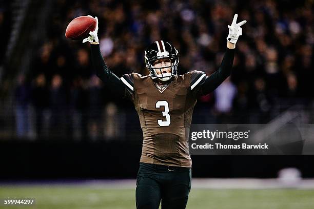 football quarterback celebrating on field - american football player celebrating stock pictures, royalty-free photos & images