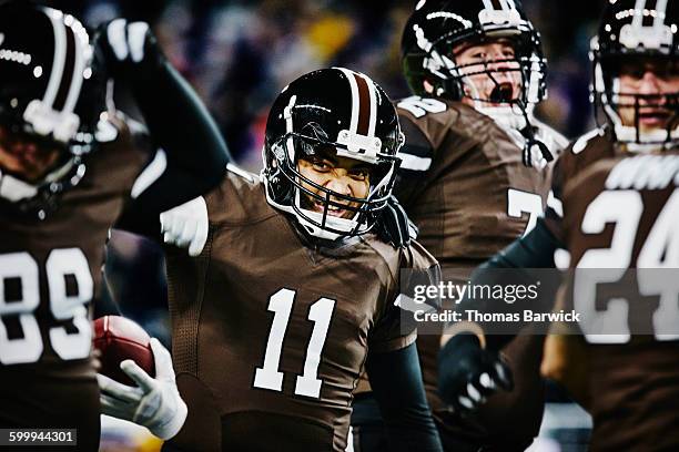 football players celebrating after winning - american football player celebrating stock pictures, royalty-free photos & images