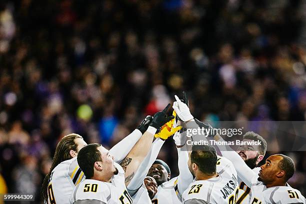 football team with arms raised after win - american society of cinematographers 19th annual outstanding achievement awards stockfoto's en -beelden