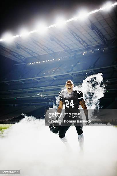 football player standing on field in fog screaming - intimidation stock pictures, royalty-free photos & images