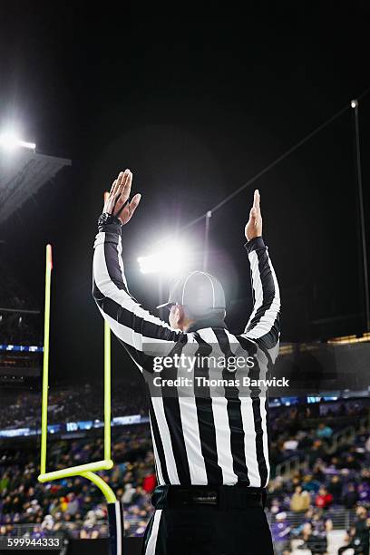 referee signaling touchdown on field during game - touchdown fotografías e imágenes de stock