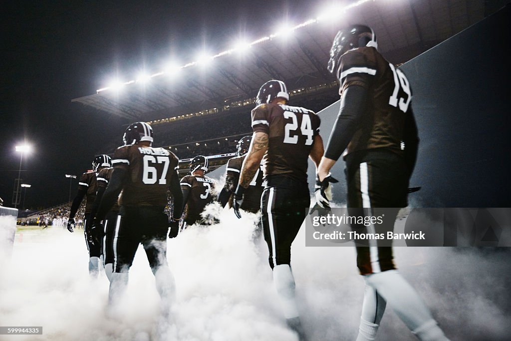 Football team walking out of stadium tunnel