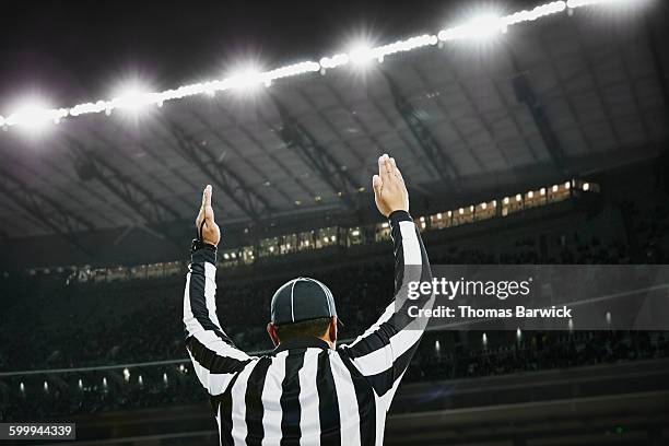 football referee signaling touchdown in stadium - scheidsrechter stockfoto's en -beelden