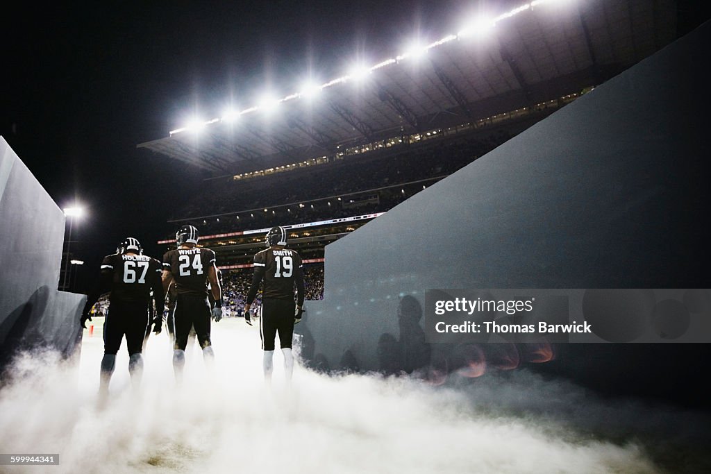 Football team walking out of stadium tunnel