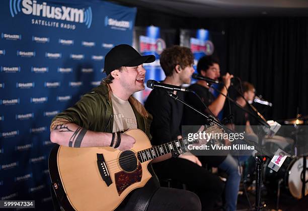 Musicians Michael Clifford, Luke Hemmings, Calum Hood, and Ashton Irwin of 5 Seconds of Summer perform at the 5 Seconds of Summer Soundcheck Party on...