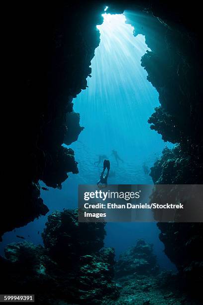 sunlight descends underwater and into a crevice on palaus barrier reef. - triángulo de coral fotografías e imágenes de stock