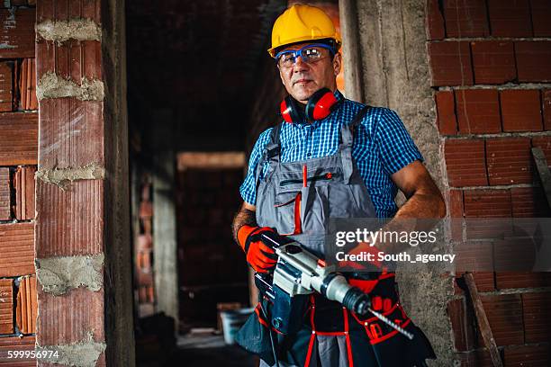 male construction worker with a drill - jackhammer stock pictures, royalty-free photos & images