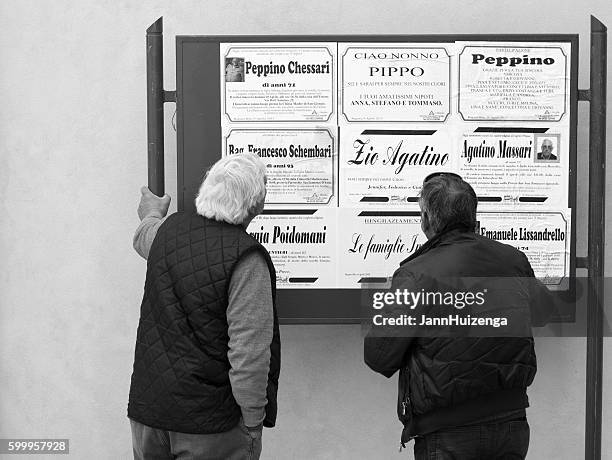 ragusa ibla, sicily: two men reading public death notices, italy - obituary stock pictures, royalty-free photos & images