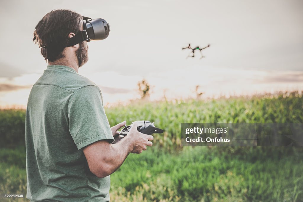 Man Flying a Drone with Virtual Reality Goggles Headset