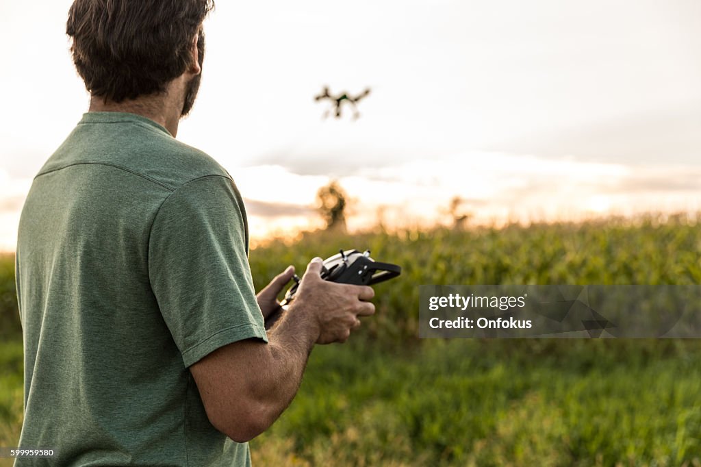 Man Flying a Drone at Sunset