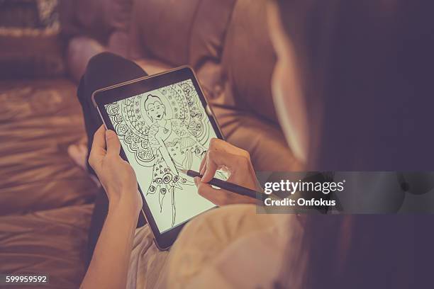 female adult drawing mandala on electronic tablet - adult coloring stock pictures, royalty-free photos & images