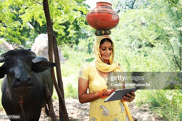 village women using digital tablet - indian village people stock pictures, royalty-free photos & images