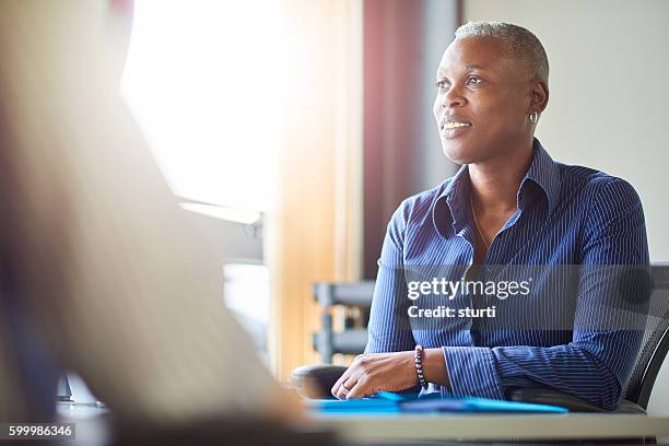 smiling businesswoman in meeting - androgynous stock pictures, royalty-free photos & images