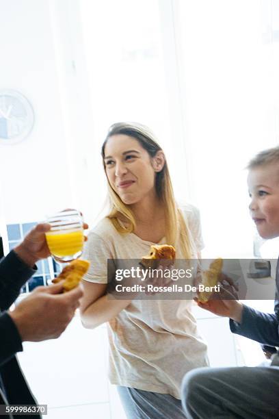 happy family having breakfast together in the kitchen - pain au chocolat stock pictures, royalty-free photos & images