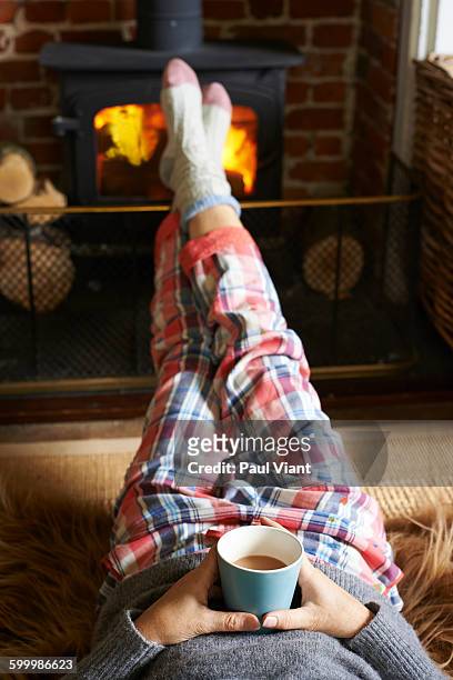 close up of cosy socks in front of fire - socks fireplace stock pictures, royalty-free photos & images