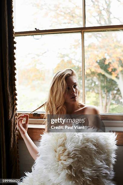 young woman wrapped in white fur blanket - hairy women imagens e fotografias de stock