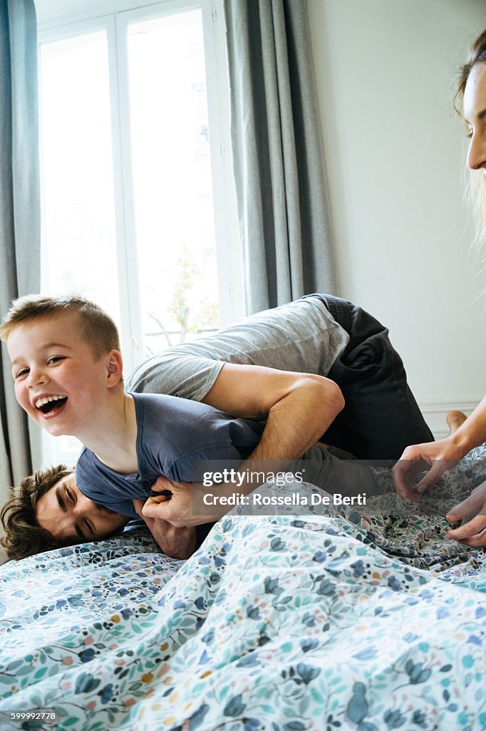 Happy Family Waking Up In The Morning, Playing in Bed