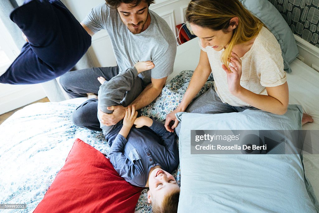 Happy Family Waking Up In The Morning, Playing in Bed