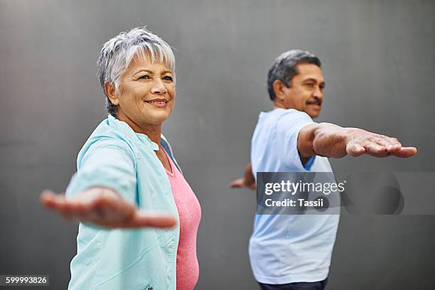 easing into retirement with some yoga - affectionate stock pictures, royalty-free photos & images