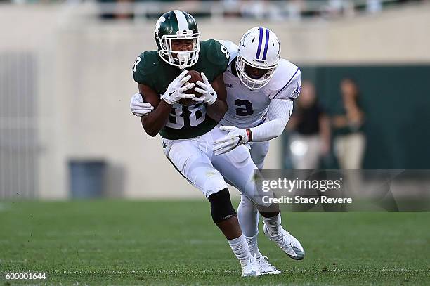 Monty Madaris of the Michigan State Spartans is pursued by Trey Robinson of the Furman Paladins during a game at Spartan Stadium on September 2, 2016...