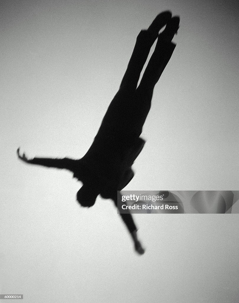 MAN WITH OUTSTRETCHED ARMS IN MIDAIR